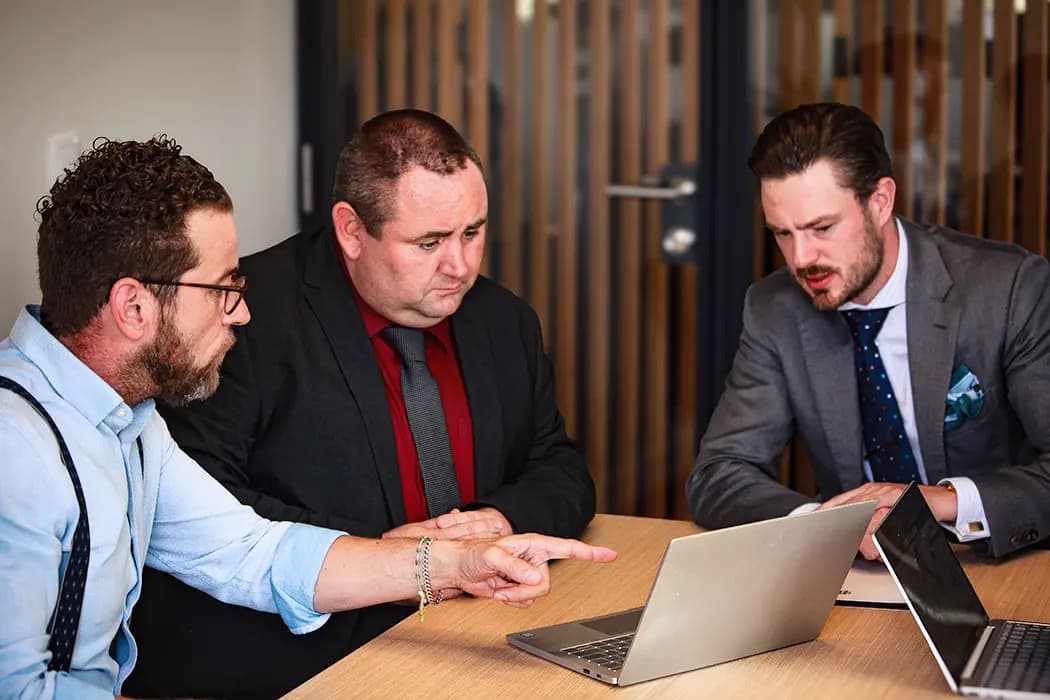 Professional business discussion between colleagues in a private meeting room
